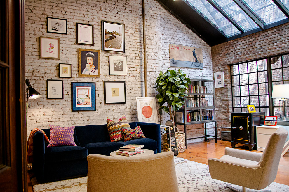 This is an example of a large industrial enclosed games room in New York with medium hardwood flooring, brown floors and multi-coloured walls.