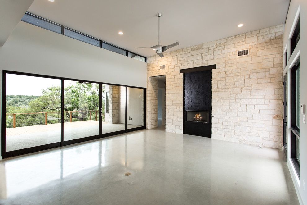 Inspiration for a large contemporary open plan games room in Austin with white walls, concrete flooring, a ribbon fireplace, a concrete fireplace surround and no tv.