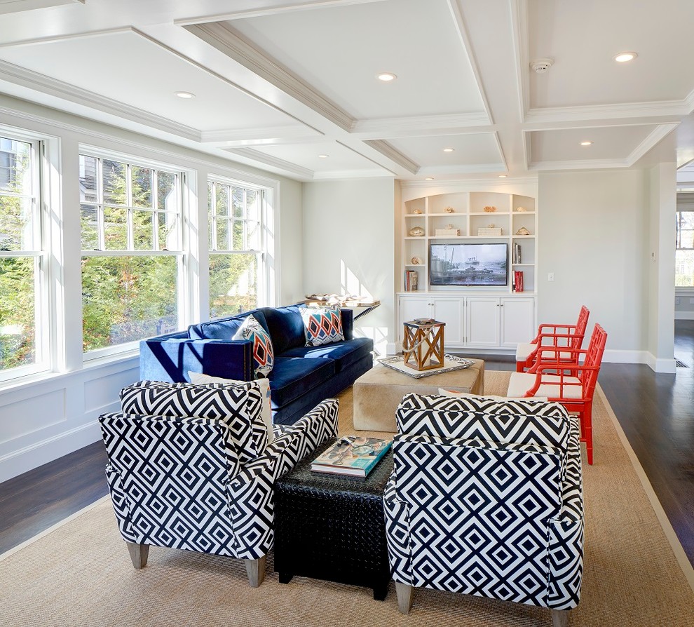 This is an example of a medium sized beach style open plan games room in Boston with grey walls, dark hardwood flooring, a built-in media unit and brown floors.