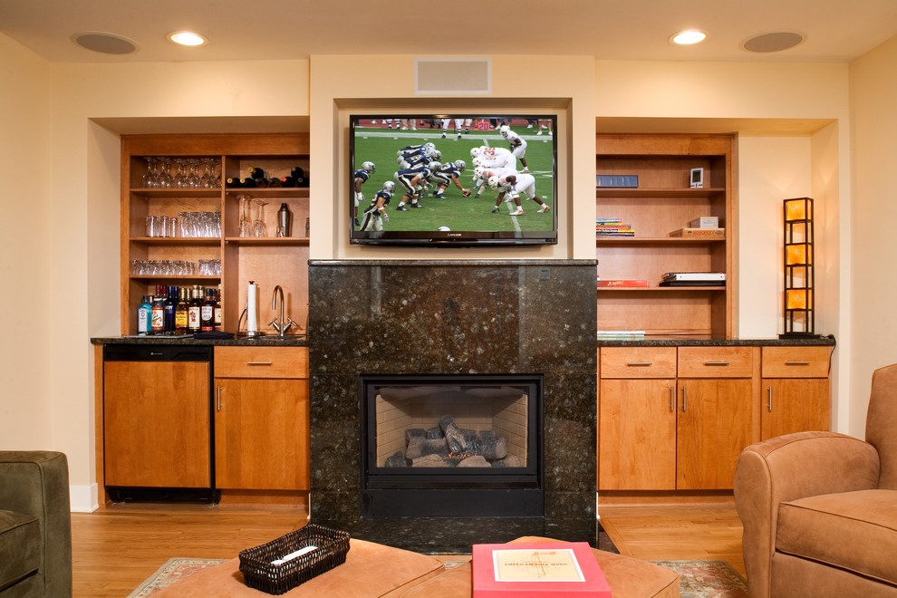 Example of a mid-sized trendy enclosed light wood floor family room design in Chicago with a bar, beige walls, a standard fireplace, a stone fireplace and a wall-mounted tv