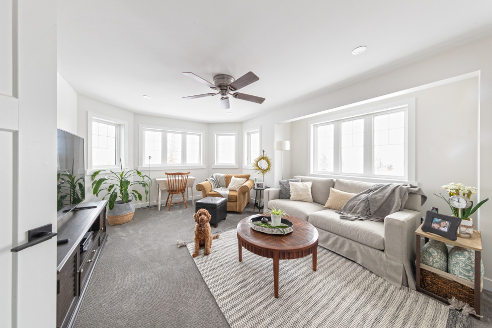 Family room - large craftsman enclosed vinyl floor, brown floor and vaulted ceiling family room idea in Edmonton with white walls