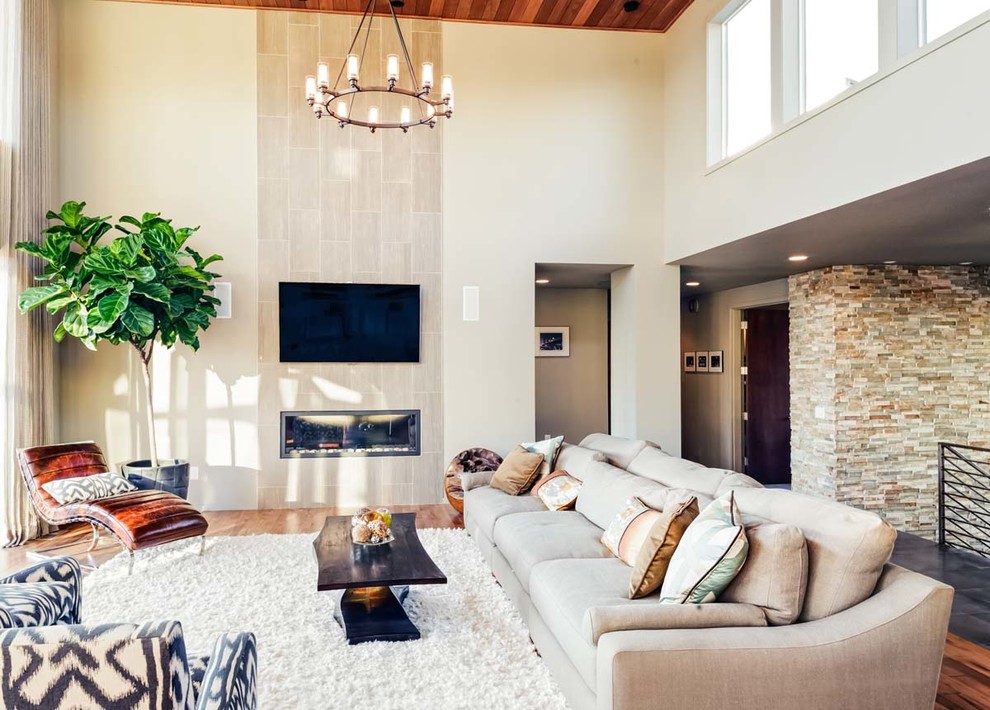 Inspiration for a large contemporary open concept medium tone wood floor family room remodel in Jacksonville with beige walls, a ribbon fireplace and a wall-mounted tv