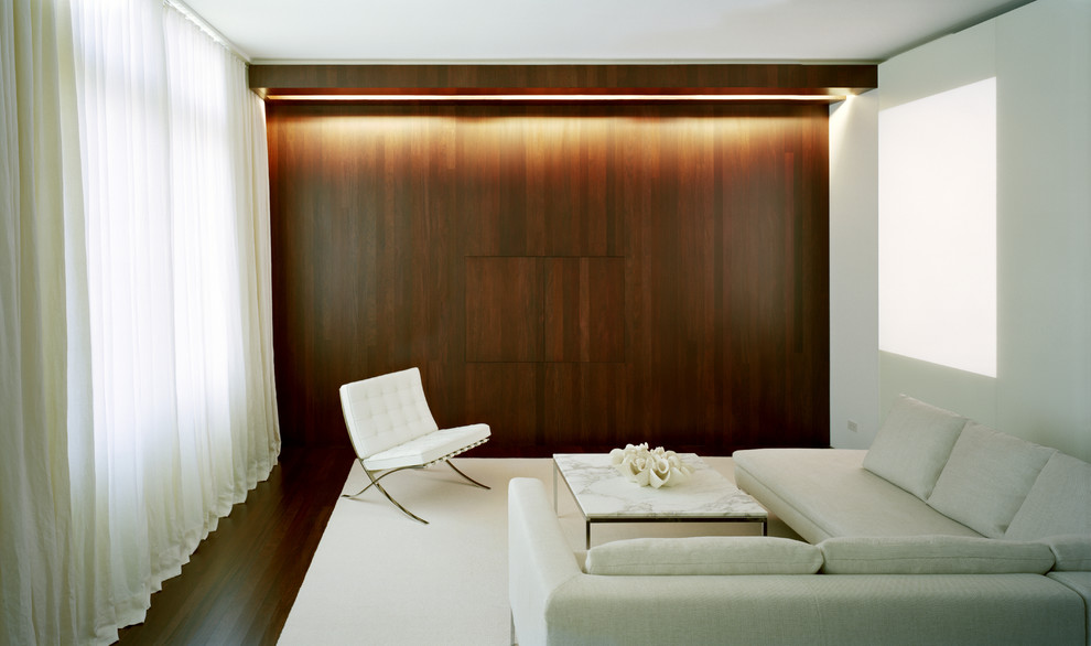 Example of a minimalist living room design in New York with white walls