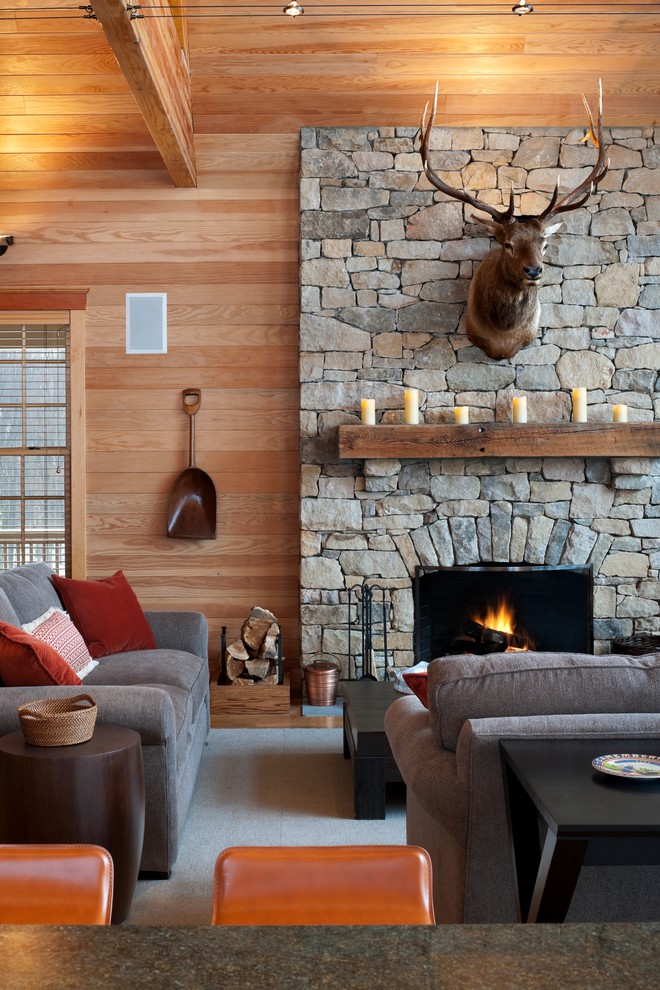 Family room - rustic family room idea in Philadelphia with a standard fireplace, a stone fireplace and no tv
