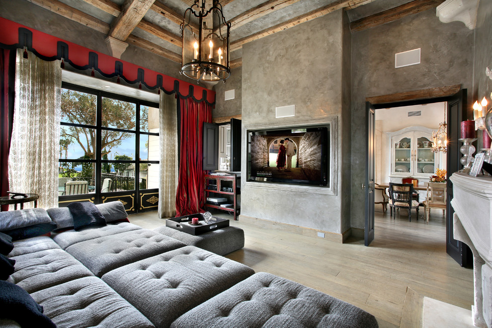 Tuscan light wood floor family room photo in Orange County with gray walls and a wall-mounted tv