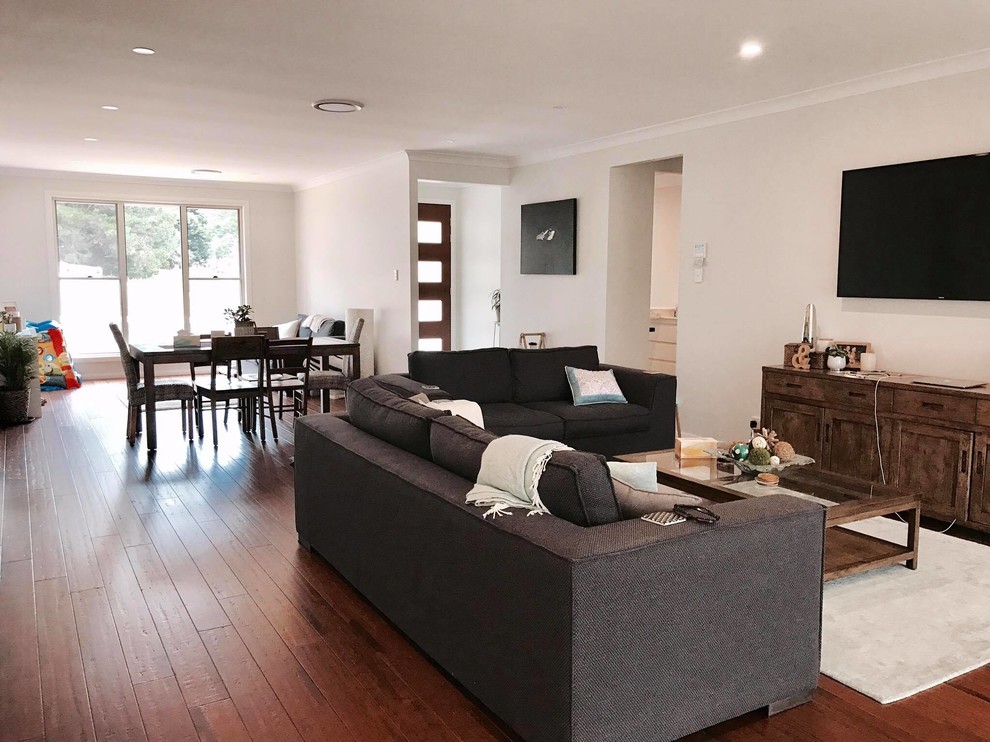 Photo of a large contemporary open plan games room in Sydney with white walls, bamboo flooring, no fireplace and a wall mounted tv.