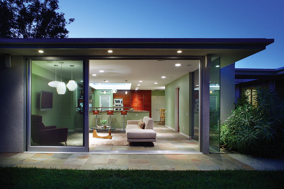 This is an example of a medium sized contemporary open plan games room in Los Angeles with green walls and slate flooring.