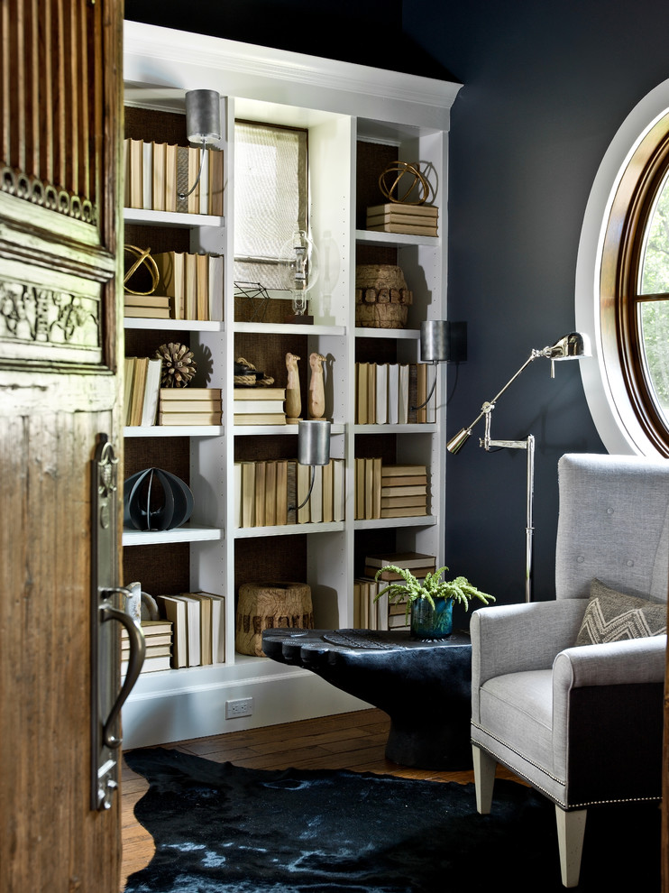 Foto de sala de estar con biblioteca clásica renovada con paredes negras y suelo de madera oscura