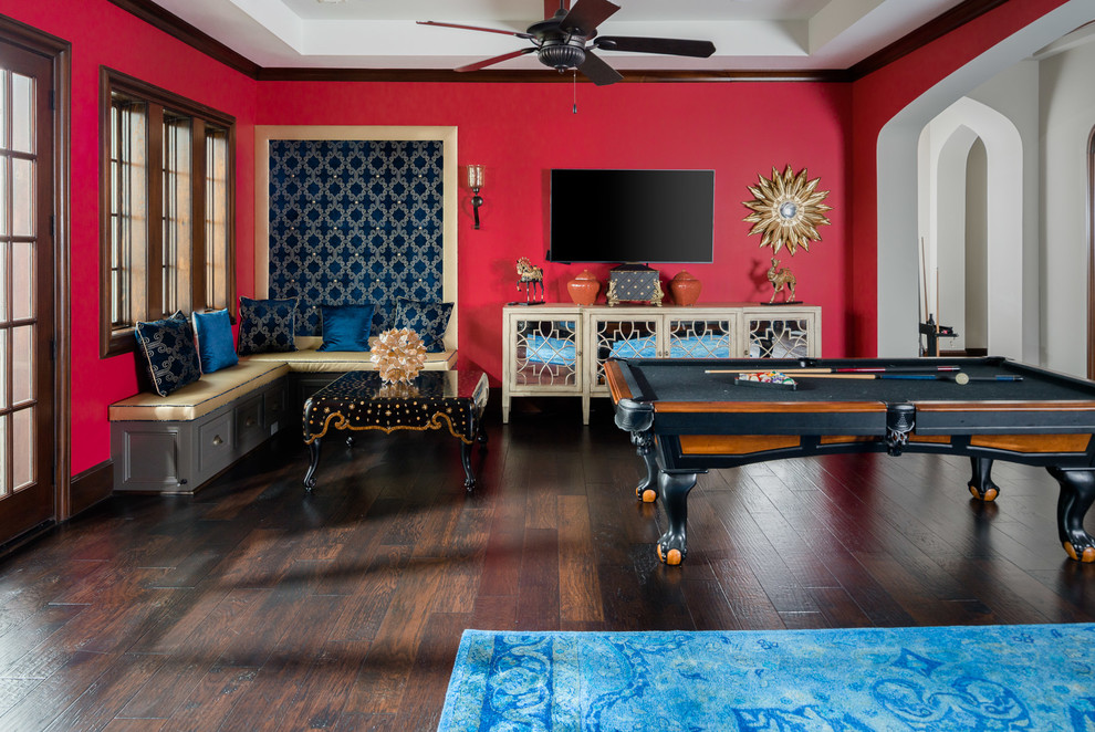 Medium sized mediterranean enclosed games room in Houston with a game room, red walls, dark hardwood flooring, a wall mounted tv and brown floors.