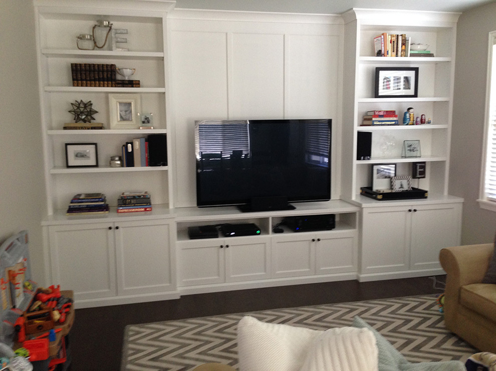 Example of a mid-sized classic dark wood floor family room design in Seattle with gray walls and a media wall