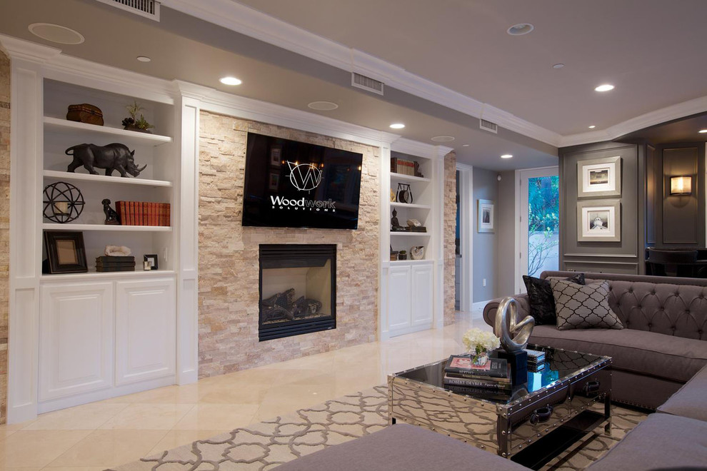 Example of a mid-sized transitional open concept family room design in Orange County with beige walls and a media wall