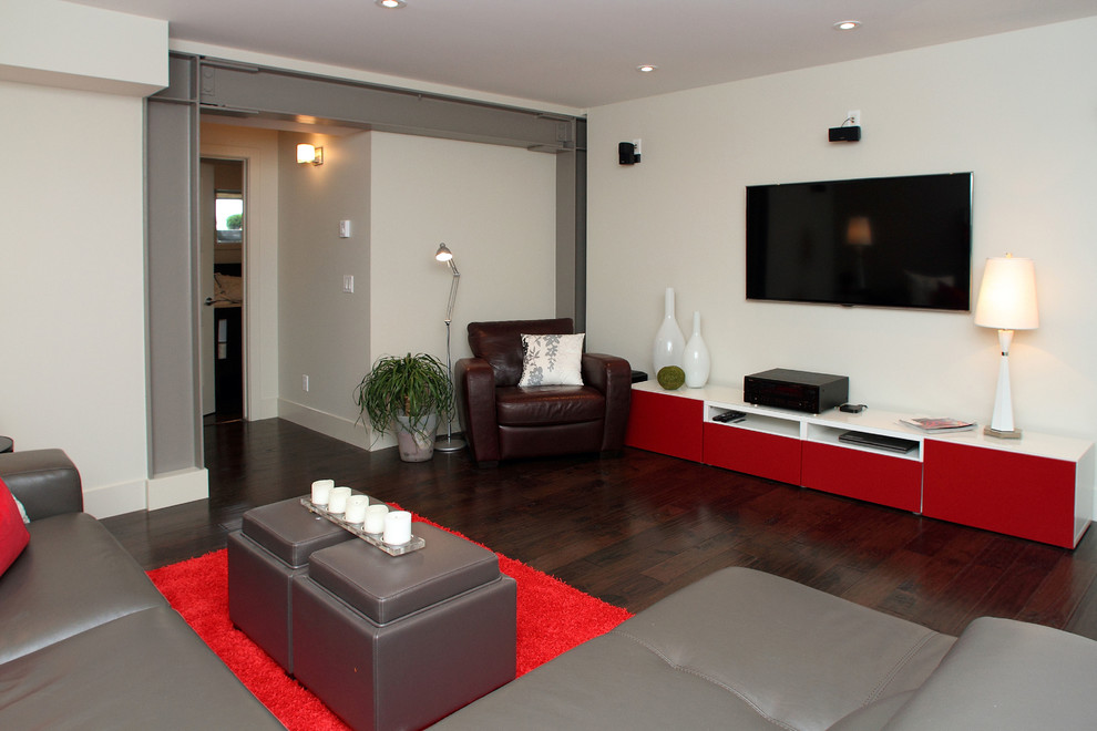Inspiration for a large contemporary enclosed games room in Calgary with grey walls, dark hardwood flooring, no fireplace and a wall mounted tv.