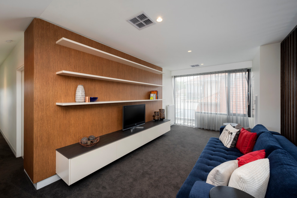 Example of a mid-sized trendy loft-style ceramic tile and gray floor family room design in Melbourne with a media wall