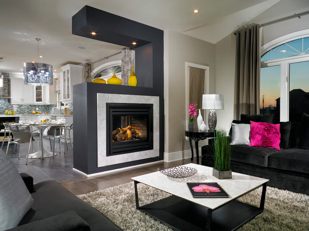 Family room - contemporary family room idea in Toronto with a two-sided fireplace