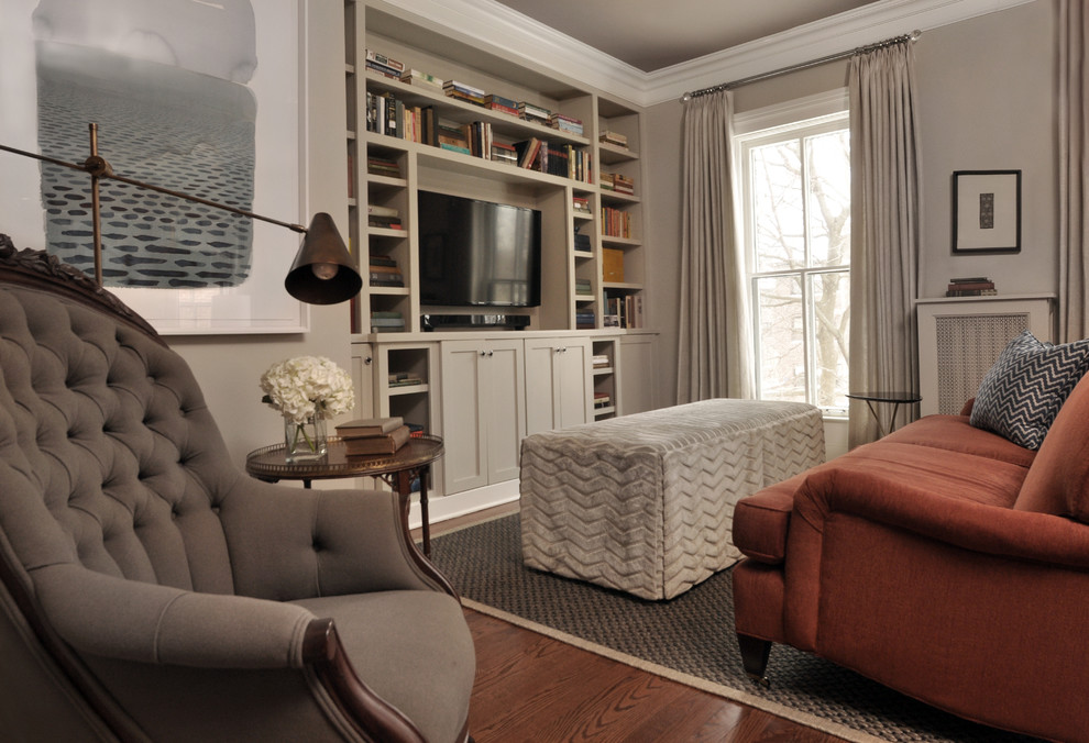 Large transitional open concept medium tone wood floor family room library photo in Chicago with gray walls, a standard fireplace, a wood fireplace surround and a media wall
