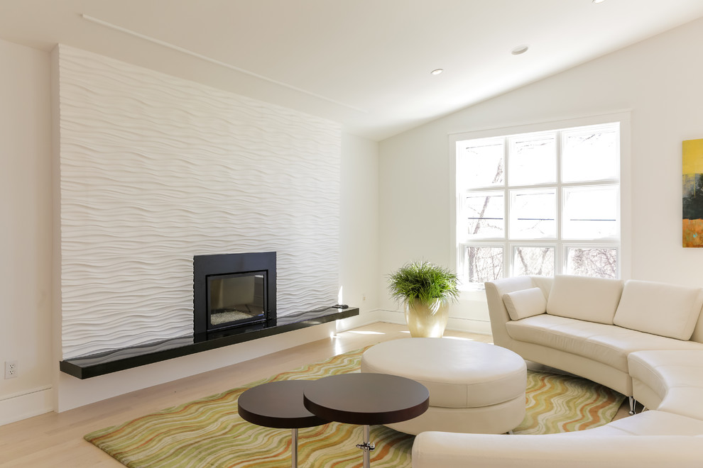 Photo of a medium sized modern open plan games room in Denver with white walls, light hardwood flooring, a standard fireplace and beige floors.
