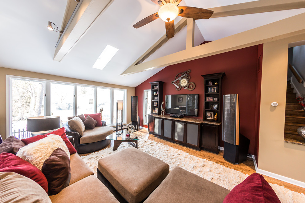 Exemple d'une grande salle de séjour chic ouverte avec un mur rouge, un sol en bois brun, un téléviseur encastré, une salle de musique et un sol multicolore.