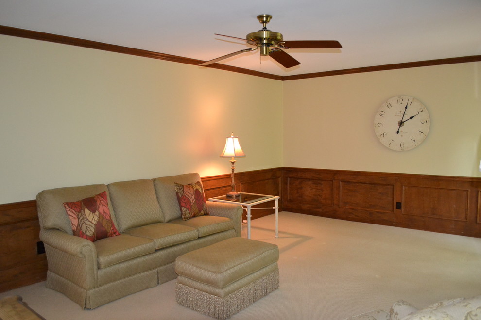 Family room - traditional enclosed carpeted family room idea in Atlanta with beige walls, a standard fireplace and a brick fireplace