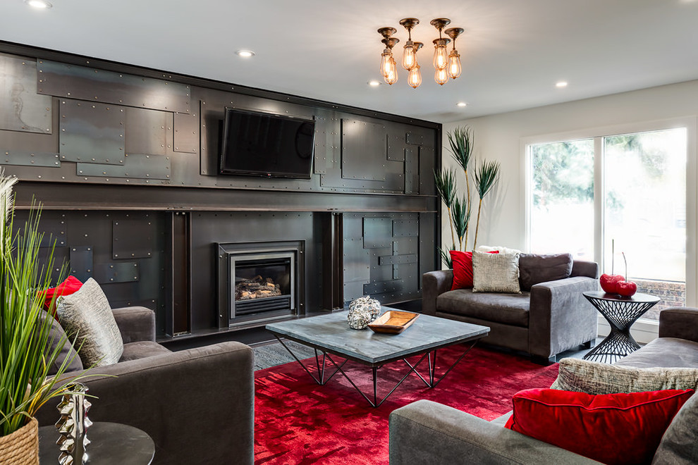 Large urban enclosed games room in Calgary with white walls, a wall mounted tv, carpet, a standard fireplace, a metal fireplace surround and a feature wall.