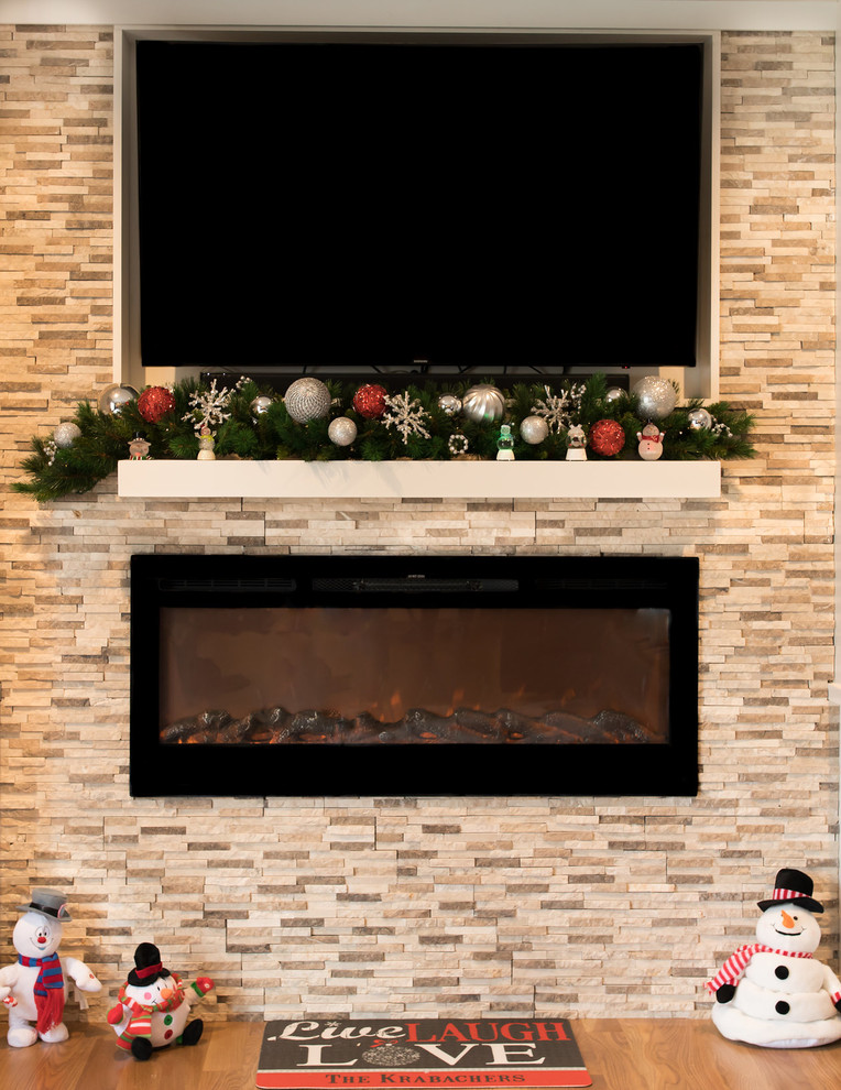 Example of a small minimalist open concept medium tone wood floor and brown floor family room design in Cincinnati with beige walls, a standard fireplace, a stone fireplace and a wall-mounted tv