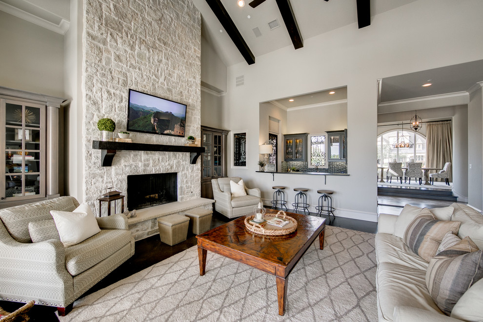 This is an example of a large nautical open plan living room in Dallas with grey walls, dark hardwood flooring, a standard fireplace, a stone fireplace surround, a wall mounted tv and feature lighting.