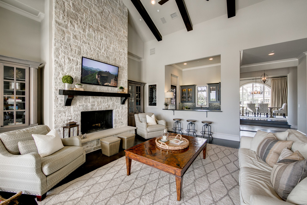 Inspiration for a large coastal open concept dark wood floor family room remodel in Dallas with gray walls, a standard fireplace, a stone fireplace and a wall-mounted tv