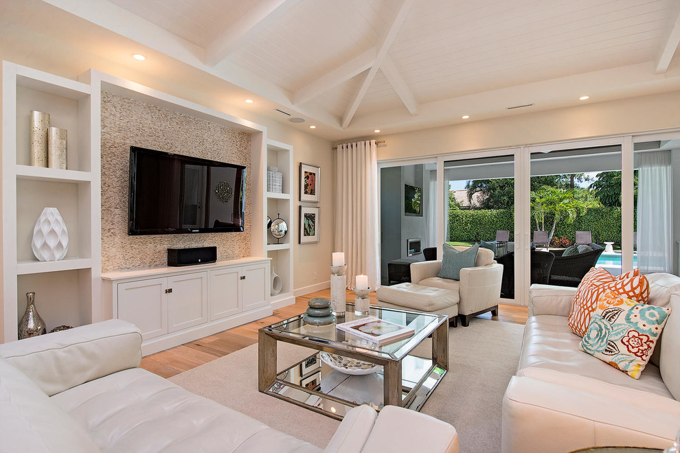 Family room - transitional medium tone wood floor family room idea in Miami with beige walls, no fireplace and a wall-mounted tv