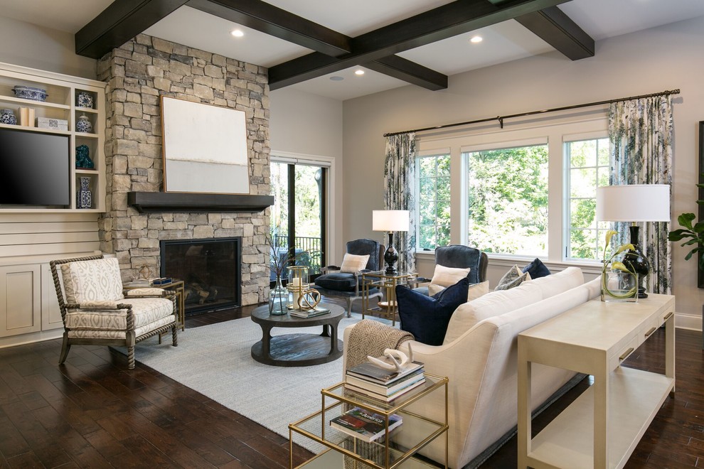 Medium sized traditional open plan games room in Kansas City with grey walls, medium hardwood flooring, a standard fireplace, a stone fireplace surround, a built-in media unit and brown floors.