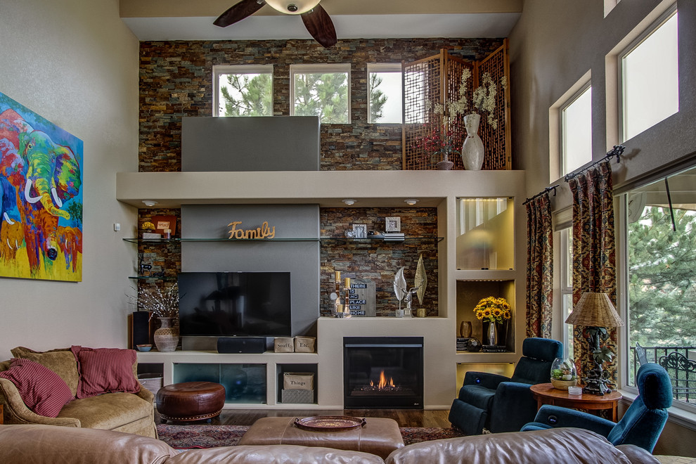 Contemporary open plan games room in Denver with beige walls, dark hardwood flooring, a standard fireplace, a stone fireplace surround and a built-in media unit.