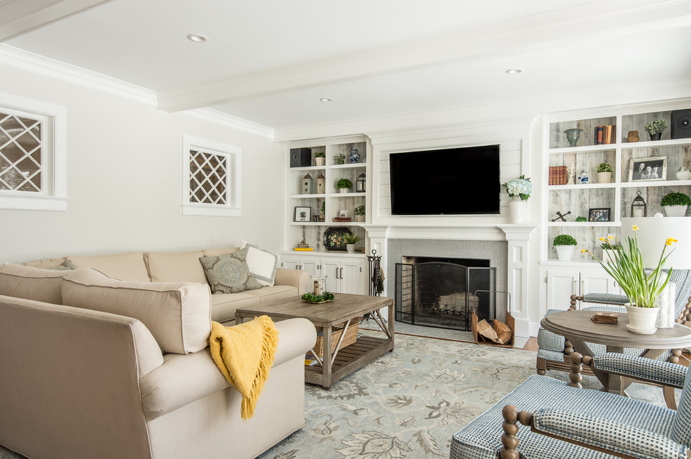 Inspiration for a large transitional open concept medium tone wood floor family room remodel in Bridgeport with gray walls, a standard fireplace, a tile fireplace and a wall-mounted tv