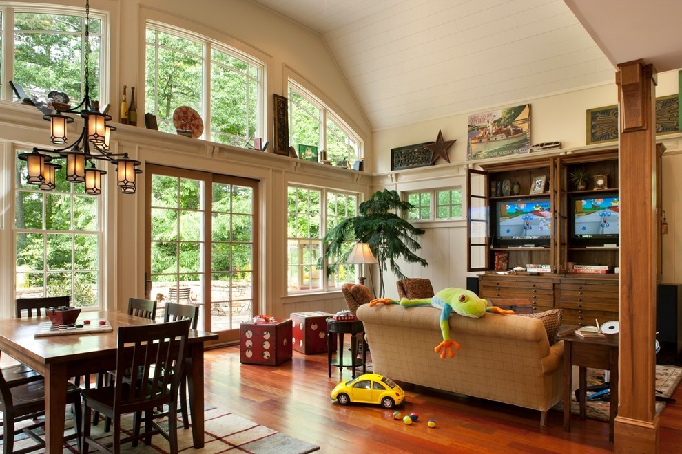 Photo of a medium sized rustic open plan games room in Nashville with beige walls, medium hardwood flooring, no fireplace, a wall mounted tv and brown floors.