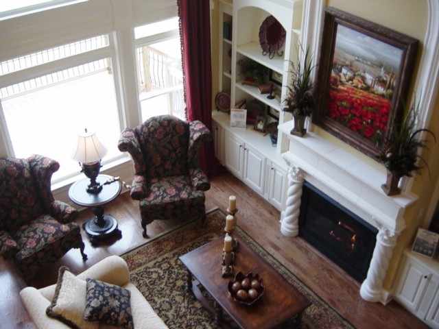 Photo of a large traditional open plan games room in Atlanta with beige walls, light hardwood flooring, a standard fireplace and feature lighting.