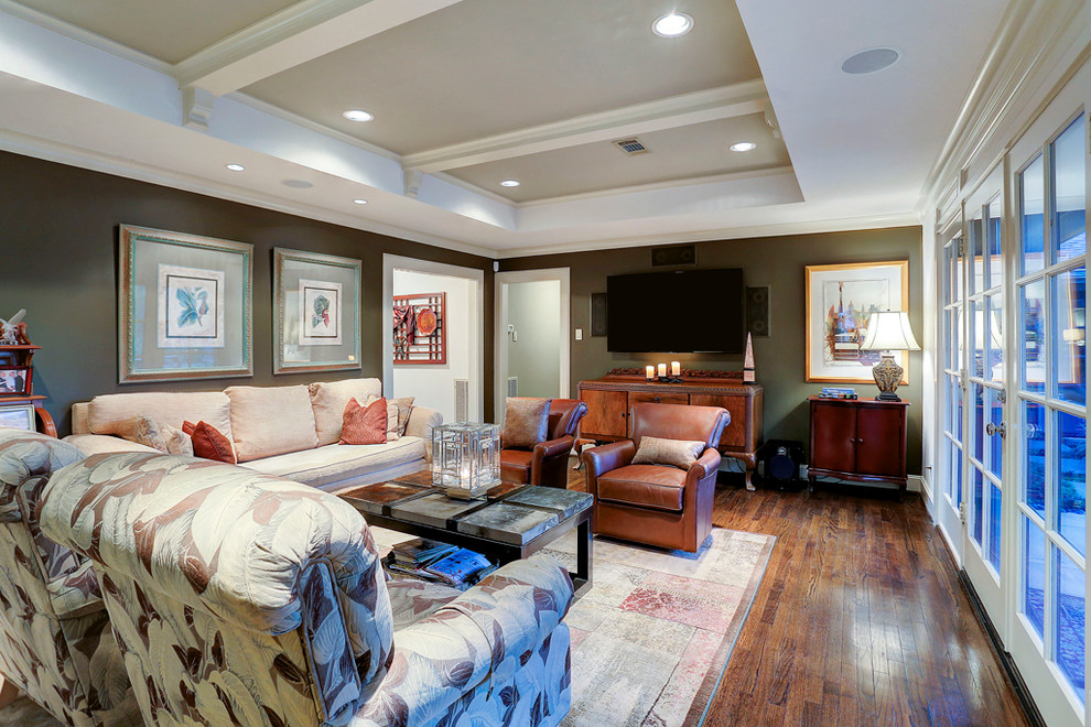 This is an example of a modern games room in Houston with dark hardwood flooring and a wall mounted tv.