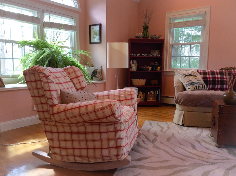 Imagen de sala de estar cerrada campestre de tamaño medio sin chimenea con paredes rosas, suelo de madera en tonos medios y televisor retractable