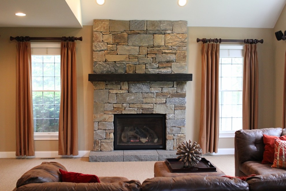 Inspiration for a timeless carpeted family room remodel in Philadelphia with a stone fireplace and a standard fireplace