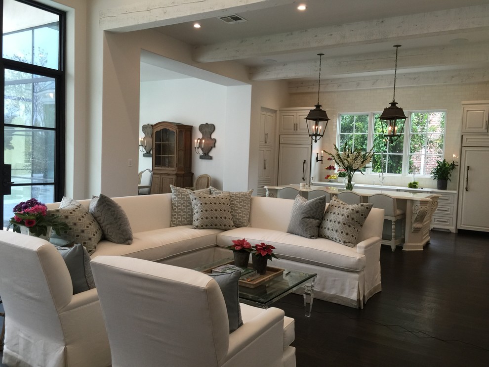This is an example of an expansive classic open plan games room in Houston with white walls and dark hardwood flooring.