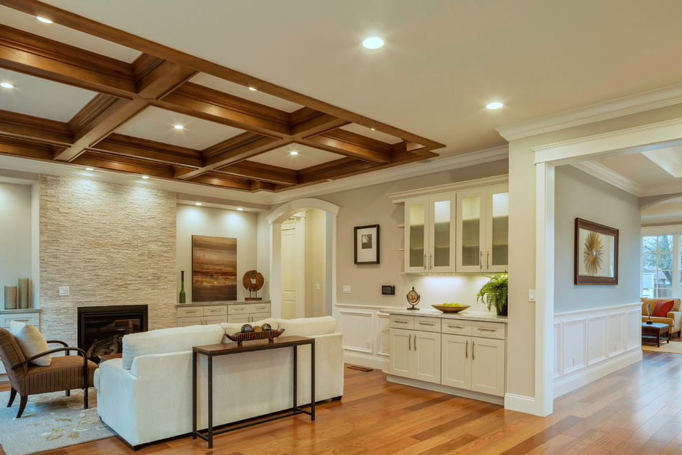 Inspiration for a large traditional open plan games room in San Francisco with a home bar, grey walls, medium hardwood flooring, a standard fireplace, a stone fireplace surround and a wall mounted tv.
