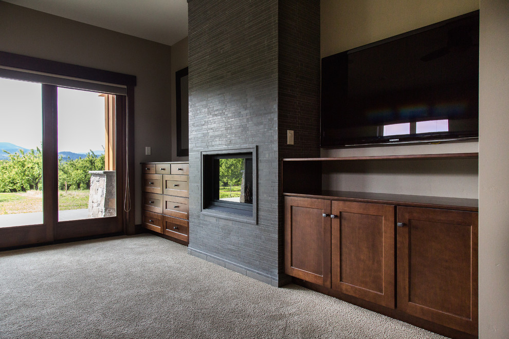 Medium sized classic open plan games room in Portland with beige walls, carpet, a standard fireplace, a tiled fireplace surround and a wall mounted tv.