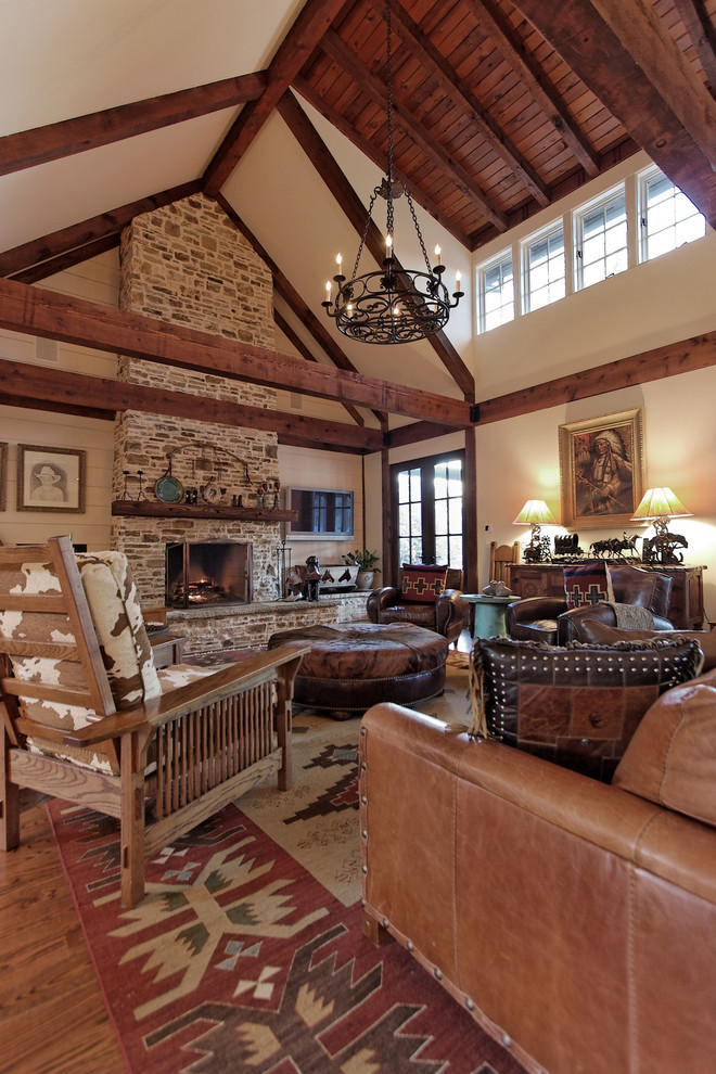 Inspiration for a rustic family room remodel in Atlanta with a stone fireplace