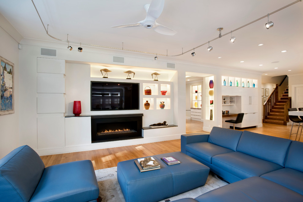 Photo of a large contemporary games room in Boston with a ribbon fireplace and a stone fireplace surround.