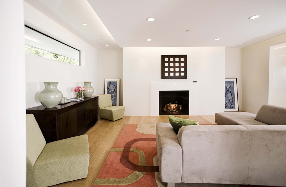 Inspiration for a contemporary living room in San Francisco with white walls, a standard fireplace and bamboo flooring.