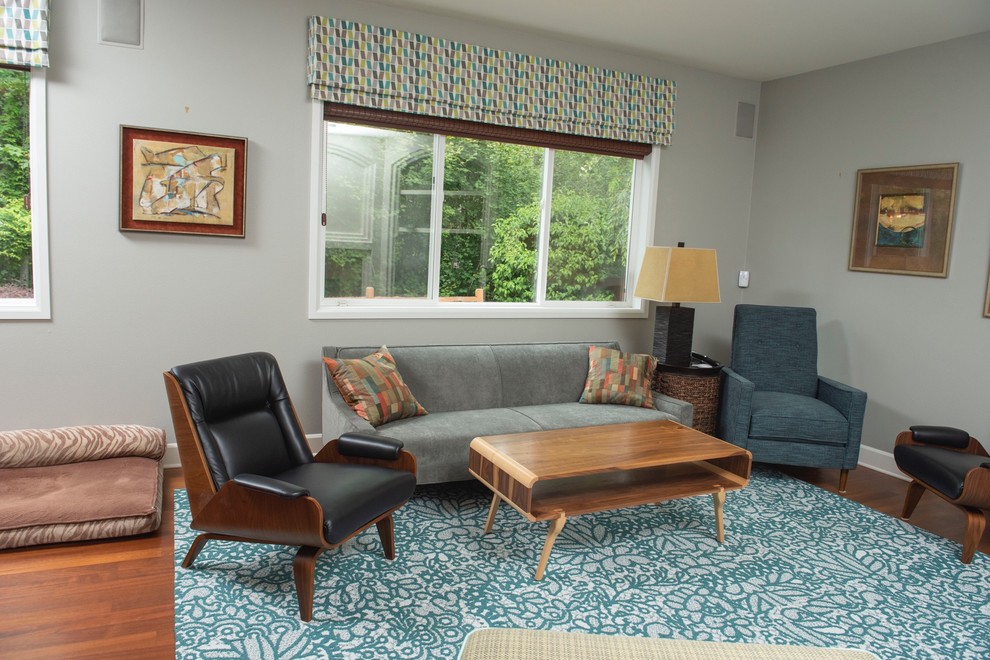 Exemple d'une salle de séjour rétro de taille moyenne et ouverte avec un mur gris, un sol en bois brun et un manteau de cheminée en carrelage.