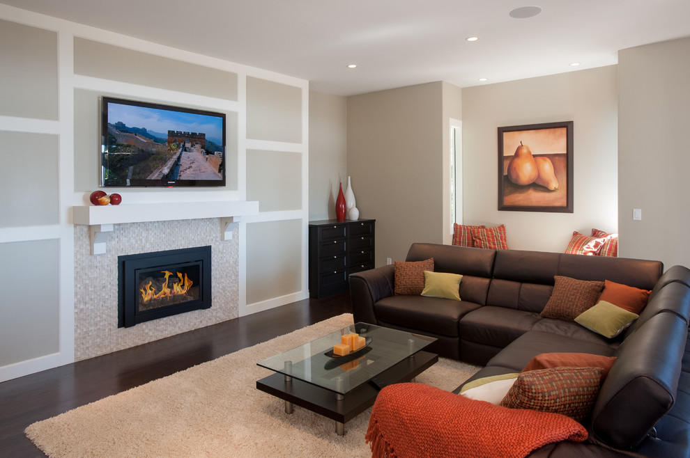 Inspiration for a mid-sized contemporary open concept dark wood floor family room remodel in Vancouver with beige walls, a standard fireplace, a tile fireplace and a wall-mounted tv