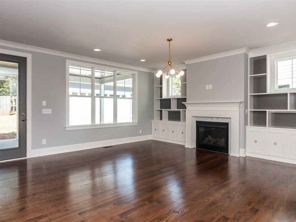 Example of a large transitional open concept medium tone wood floor family room design in Raleigh with gray walls, a standard fireplace, a tile fireplace and a wall-mounted tv