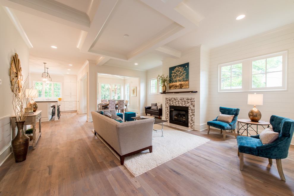 Photo of a large traditional open plan games room in Charlotte with white walls, medium hardwood flooring, a standard fireplace, a tiled fireplace surround and brown floors.