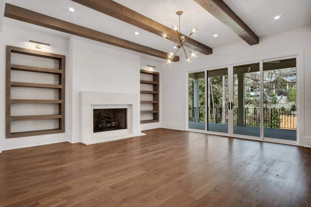 Design ideas for a large traditional open plan games room in Atlanta with white walls, medium hardwood flooring, a standard fireplace, a stone fireplace surround, a wall mounted tv and grey floors.
