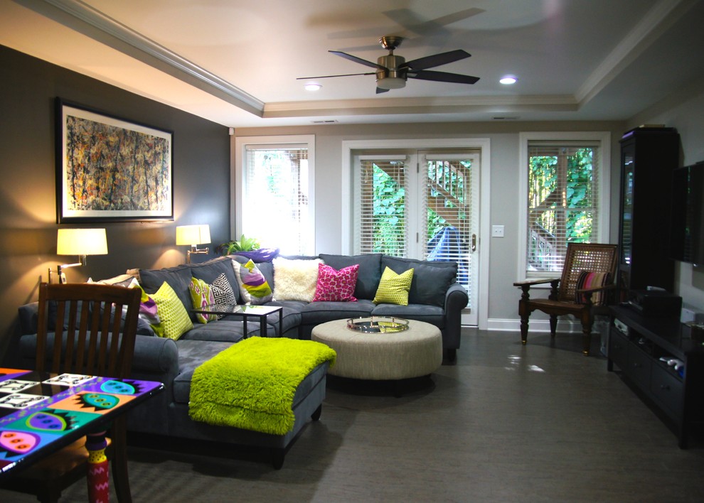 This is an example of a contemporary open plan games room in Raleigh with a home bar, multi-coloured walls, a wall mounted tv and dark hardwood flooring.