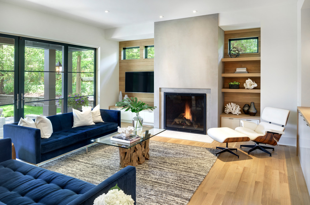 Inspiration for a large transitional open concept light wood floor family room remodel in Minneapolis with white walls, a standard fireplace, a concrete fireplace and a wall-mounted tv
