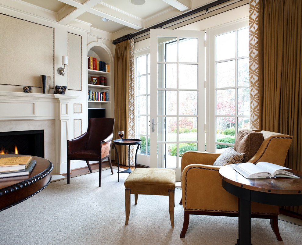 Example of a classic family room design in DC Metro with beige walls and a standard fireplace