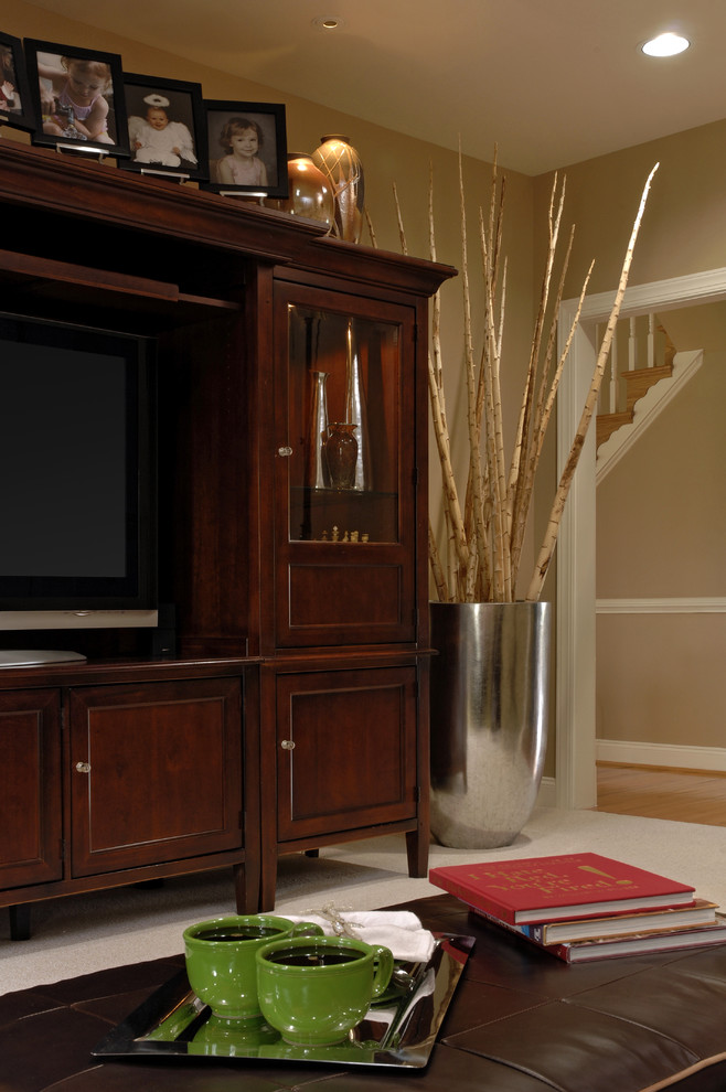 Elegant carpeted family room photo in DC Metro with beige walls and a tv stand